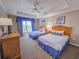 Comfortable bedroom featuring two twin beds, a ceiling fan, and a window providing natural light at 9994 Beach Club Dr. # 706, Myrtle Beach, SC 29572