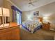 Cozy bedroom with a ceiling fan, balcony access, and a dresser provides a relaxing retreat for rest and rejuvenation at 9994 Beach Club Dr. # 706, Myrtle Beach, SC 29572