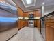 Modern kitchen with stainless steel appliances, light wood cabinets and tiled floor at 9994 Beach Club Dr. # 706, Myrtle Beach, SC 29572