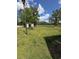 Expansive backyard with lush grass, a utility shed, and scattered weeds at 1014 Mimosa Ct., Conway, SC 29527