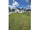 Side view of a home's backyard, showcasing a white picket fence, lawn, and the house's exterior at 1014 Mimosa Ct., Conway, SC 29527