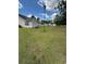 Backyard of a home with a large lawn, white picket fence, and other outbuildings at 1014 Mimosa Ct., Conway, SC 29527