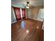 Bedroom with ceiling fan, wood flooring and window with red curtains at 1014 Mimosa Ct., Conway, SC 29527