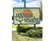 Jasmine Woods neighborhood sign with yellow flowers and green foliage at 1014 Mimosa Ct., Conway, SC 29527