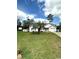 Charming single-story home with well-maintained lawn, mature palm tree, and a driveway leading to an attached garage at 1014 Mimosa Ct., Conway, SC 29527