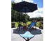 Outdoor patio with seating under an umbrella, creating a cozy space for relaxation and entertainment at 1210 Horry Rd., Aynor, SC 29511