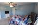 Bedroom featuring a patriotic themed comforter set, a ceiling fan, and a TV on a dresser at 1210 Horry Rd., Aynor, SC 29511