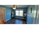 Cozy bedroom with light blue walls, a ceiling fan, a window with natural light, and stylish wood-look flooring at 1210 Horry Rd., Aynor, SC 29511
