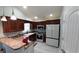 Modern kitchen with stainless steel appliances, dark cabinets, and light countertops at 1210 Horry Rd., Aynor, SC 29511
