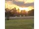 Picturesque sunset view over a field and trees, casting a warm glow on the serene landscape at 1210 Horry Rd., Aynor, SC 29511
