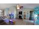 Bright living room with a fireplace, ceiling fan, and views into the dining area at 1210 Horry Rd., Aynor, SC 29511