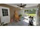 Relaxing screened-in porch with a rocking chair, ceiling fan, and view of the yard at 1210 Horry Rd., Aynor, SC 29511