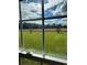 Scenic view from the window overlooking a lush green lawn and distant trees against a blue sky at 1210 Horry Rd., Aynor, SC 29511