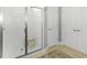 This bathroom features a glass shower, a small wooden bench, and two white doors at 1406 Seabrook Plantation Way, North Myrtle Beach, SC 29582