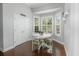 Bright breakfast nook with hardwood floors, a white table, and an abundance of natural light at 1406 Seabrook Plantation Way, North Myrtle Beach, SC 29582