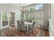 Elegant dining room with hardwood floors, a chandelier, and large windows at 1406 Seabrook Plantation Way, North Myrtle Beach, SC 29582