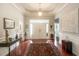 Grand foyer with hardwood floors, tray ceiling, stylish console table, and decorative rug at 1406 Seabrook Plantation Way, North Myrtle Beach, SC 29582