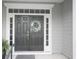 Elegant double front doors with decorative wreath, sidelights, and covered porch at 1406 Seabrook Plantation Way, North Myrtle Beach, SC 29582