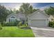 Charming single-story home with a well-manicured lawn, beautiful landscaping, and attached two-car garage at 1406 Seabrook Plantation Way, North Myrtle Beach, SC 29582