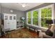 This living room has seating, a bookcase, a ceiling fan, and windows to the yard at 1406 Seabrook Plantation Way, North Myrtle Beach, SC 29582