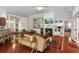 Open-concept living room featuring hardwood floors, a fireplace, and plenty of seating at 1406 Seabrook Plantation Way, North Myrtle Beach, SC 29582