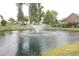 Scenic community pond featuring a fountain, lush greenery, and mature trees at 1406 Seabrook Plantation Way, North Myrtle Beach, SC 29582