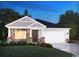 Inviting single-story home with stone accents, gray shake siding, an attached two-car garage, and a well-manicured lawn at 1570 Regal Fern Way, Longs, SC 29568