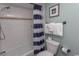 Well-lit bathroom featuring a shower/tub with white subway tile and blue striped curtain at 2001 S Ocean Blvd. # 207, Myrtle Beach, SC 29577
