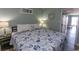 Comfortable bedroom with coastal-themed bedding and soft lighting at 2001 S Ocean Blvd. # 207, Myrtle Beach, SC 29577