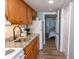 Efficient kitchen with granite countertops, wooden cabinets, and access to the bedroom at 2001 S Ocean Blvd. # 207, Myrtle Beach, SC 29577