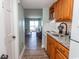 Functional kitchen featuring granite counters, wood cabinets, and seamless access to the living area at 2001 S Ocean Blvd. # 207, Myrtle Beach, SC 29577