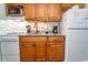 Fully equipped kitchen with granite countertops, wooden cabinetry, and modern appliances at 2001 S Ocean Blvd. # 207, Myrtle Beach, SC 29577