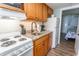Compact kitchen featuring granite counters, wood cabinetry, and essential appliances for easy meal preparation at 2001 S Ocean Blvd. # 207, Myrtle Beach, SC 29577