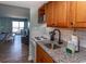 The kitchen has white appliances, wood cabinets and a granite countertop at 2001 S Ocean Blvd. # 207, Myrtle Beach, SC 29577