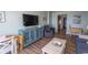 Cozy living room featuring a large TV, blue accents, and wood-style flooring at 2001 S Ocean Blvd. # 207, Myrtle Beach, SC 29577
