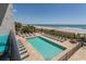 The outdoor pool is surrounded by lounge chairs and has stunning ocean views at 2001 S Ocean Blvd. # 207, Myrtle Beach, SC 29577