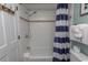 Shower and tub combination with white subway tile and nautical-themed decor at 2001 S Ocean Blvd. # 207, Myrtle Beach, SC 29577