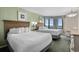 Bright bedroom with two queen beds, stylish decor, and an ocean view from the window at 2701 N Ocean Blvd. # 1154-60, Myrtle Beach, SC 29577