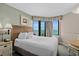 Cozy bedroom with ocean view, comfortable bed, and soothing light green walls at 2701 N Ocean Blvd. # 1154-60, Myrtle Beach, SC 29577