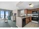 Fully equipped kitchen with stainless steel appliances and an adjoining living room with ocean views at 2701 N Ocean Blvd. # 1154-60, Myrtle Beach, SC 29577