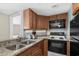 Compact kitchen with granite countertops, black appliances, and ample cabinet space at 2701 N Ocean Blvd. # 1154-60, Myrtle Beach, SC 29577