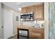 Functional kitchenette with stainless steel microwave, sink, and mini-refrigerator at 2701 N Ocean Blvd. # 1154-60, Myrtle Beach, SC 29577