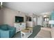 Comfortable living room with a sofa, accent chair, entertainment center, and open layout to the kitchen at 2701 N Ocean Blvd. # 1154-60, Myrtle Beach, SC 29577