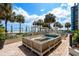 Relaxing outdoor lounge area with comfortable seating, a fire pit, and beautiful palm trees for shade at 2701 N Ocean Blvd. # 1154-60, Myrtle Beach, SC 29577