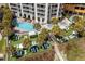 Aerial view of the building's outdoor pool, hot tub, and lounge area, surrounded by lush landscaping and palm trees at 2701 N Ocean Blvd. # 1154-60, Myrtle Beach, SC 29577