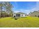 A well-maintained backyard featuring a screened porch and lush lawn, perfect for outdoor enjoyment at 3004 Fiddler Ct., Loris, SC 29569
