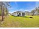 Expansive backyard with a sunroom, lush green grass, and ample space for outdoor activities at 3004 Fiddler Ct., Loris, SC 29569