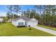Charming one-story home with manicured lawn, white siding, and blue shutters at 3004 Fiddler Ct., Loris, SC 29569