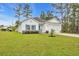 Charming one-story home with manicured lawn, white siding, and blue shutters at 3004 Fiddler Ct., Loris, SC 29569
