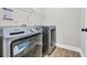 Well-equipped laundry room with modern washer and dryer units, shelving, and ample space at 3004 Fiddler Ct., Loris, SC 29569